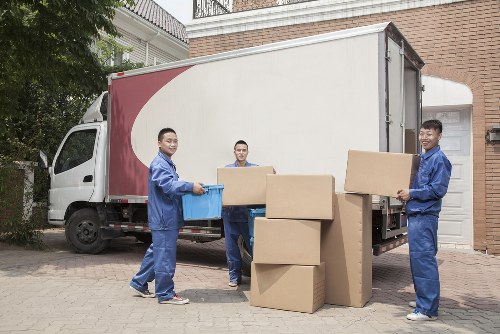 Removal team carrying furniture from a flat in Willesden