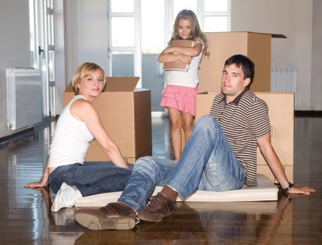 Professional removals team handling boxes and furniture in Willesden